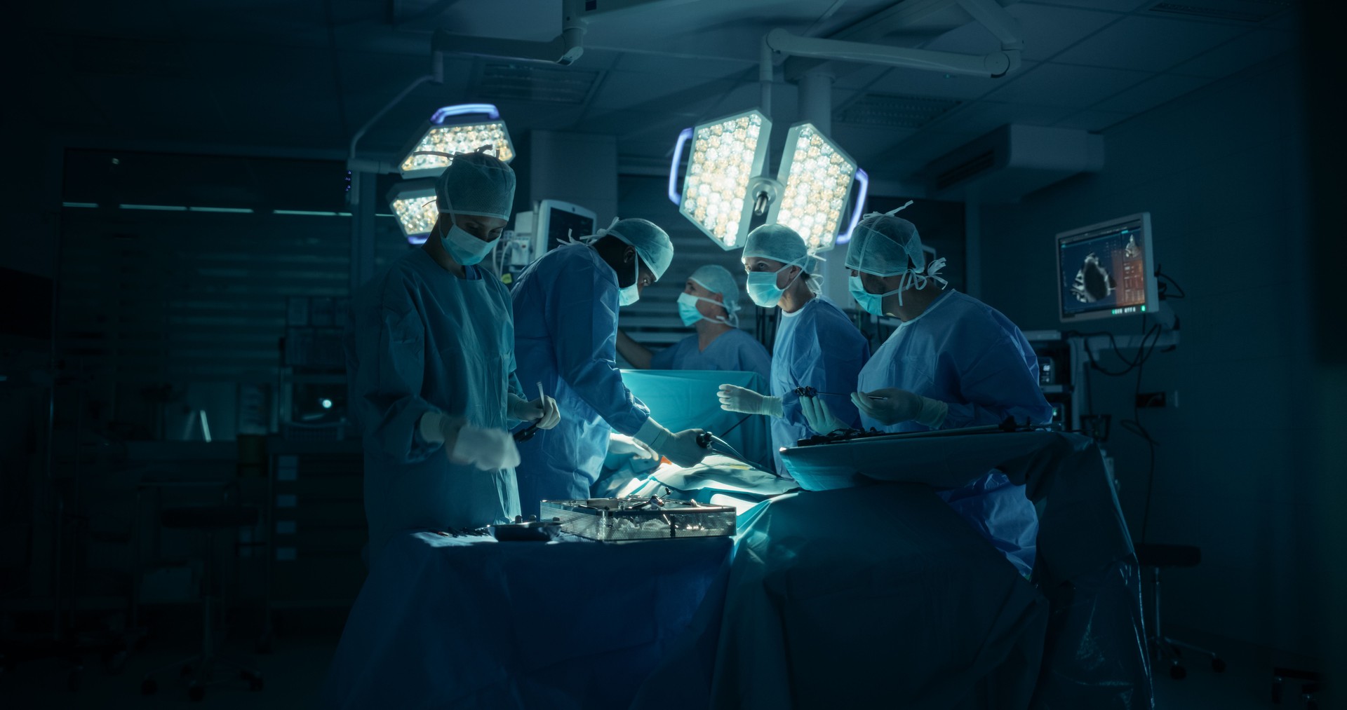 Surgeons and Assistants Maintain Steady Hands and Clear Communication as They Continue the Delicate Work of the Ongoing Surgery. Specialists Staying Calm, Monitoring Vital Readouts On the Screens